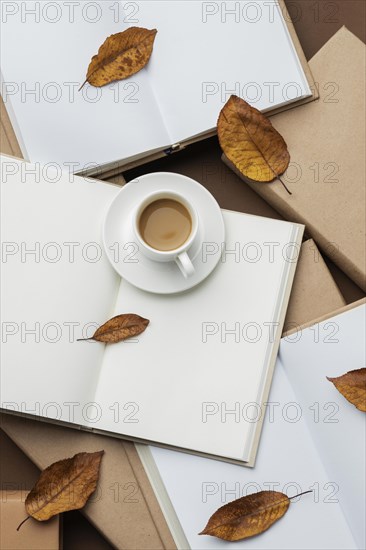 Creative arrangement with different books cup cofee