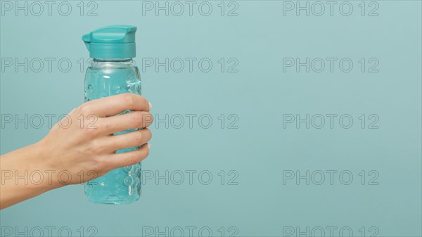 Fitness bottle filled with water copy space