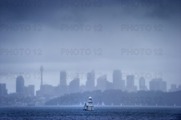 Skyline with lighthouse from Watson bay in the rain