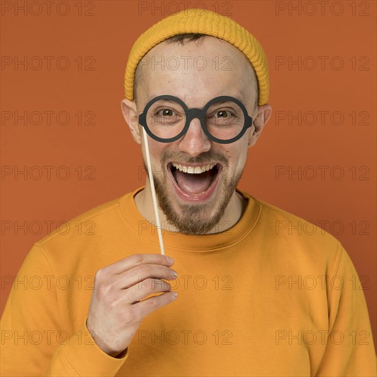 Happy young man laughing indoors 4