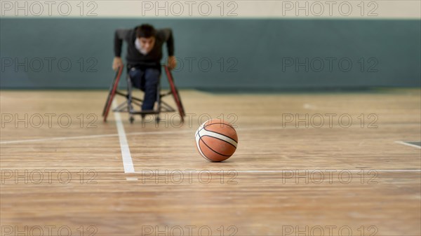 Full shot disabled man going after basketball