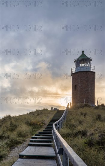 Wooden footbridge and stairs through the dunes to the lighthouse