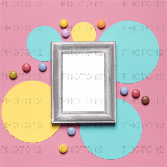 Empty blank frame with silver border circular frame with colorful gems pink background