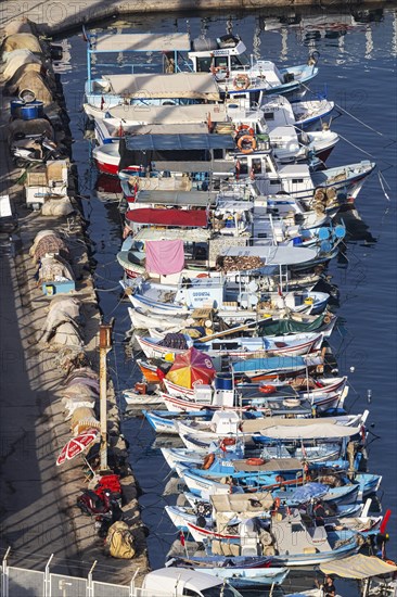Numerous colourful fishing boats moored at the jetty