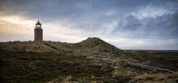 Wooden footbridge and stairs through the dunes to the lighthouse