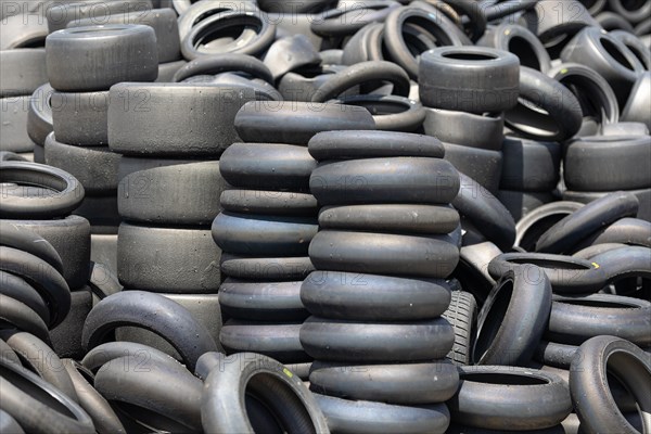 A pile of old tires sitting next to each other