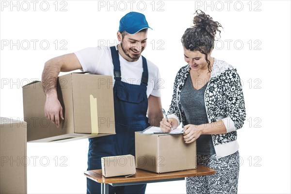 Cheerful woman courier with parcels
