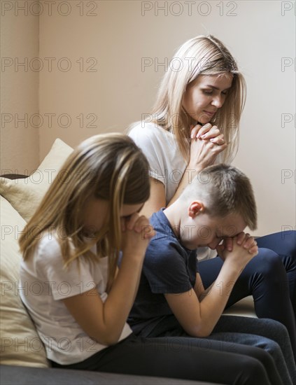 Front view family praying home