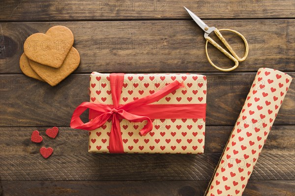 Gift box near roll sweetie paper scissors biscuits