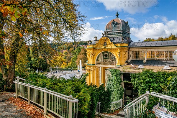 Spa colonnade with singing fountain in the autumnal spa park