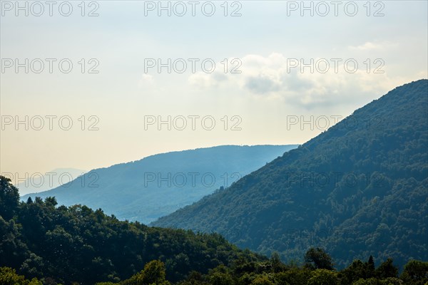 Aerial View over Mountain Range and Valley with Sky in a Sunny Summer Day in Malcantone