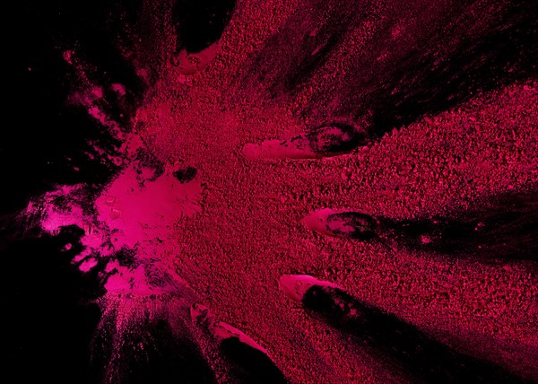 Abstract pink color powder explosion black backdrop