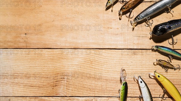 Arranged colorful fishing lure wooden desk