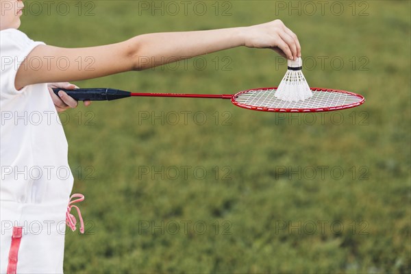 Close up girl playing badminton