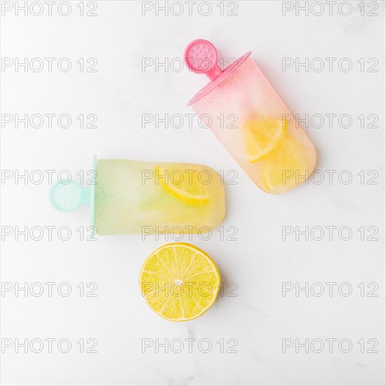 Cut lemon fresh ice popsicle with citrus colorful sticks