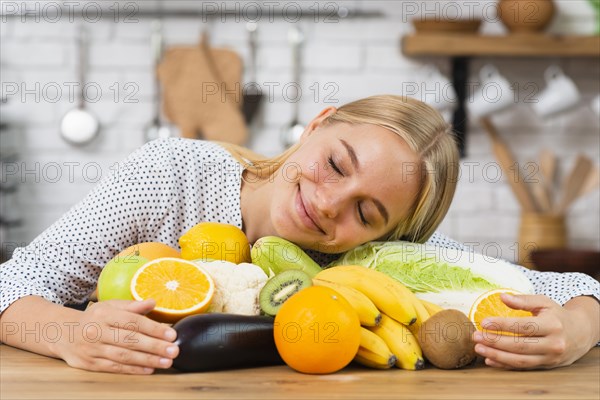 Medium shot smiley girl hugging fresh fruits