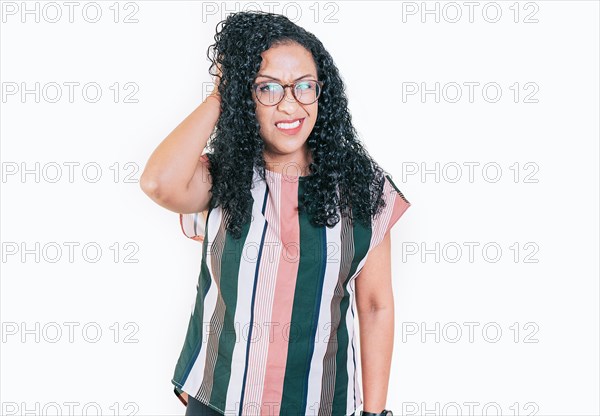 Afro woman scratching head with indecisive expression isolated. Young woman scratching her head with doubtful expression