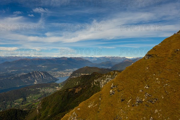 Aerial View over Beautiful Mountainscape with Snow Capped Mountain and Lake Lugano and City of Lugano in a Sunny Day From Monte Generoso