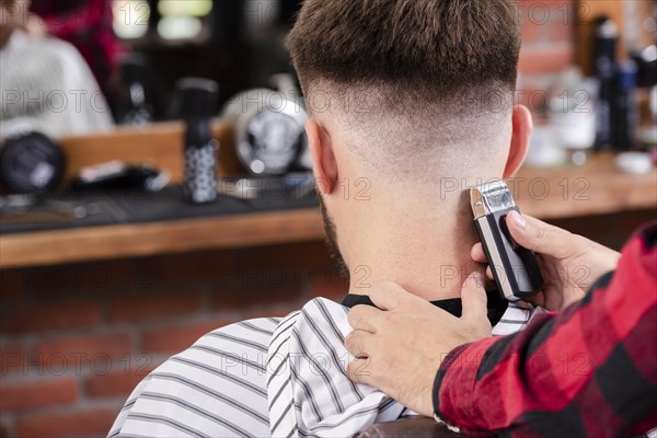 Back view barber trimming hair