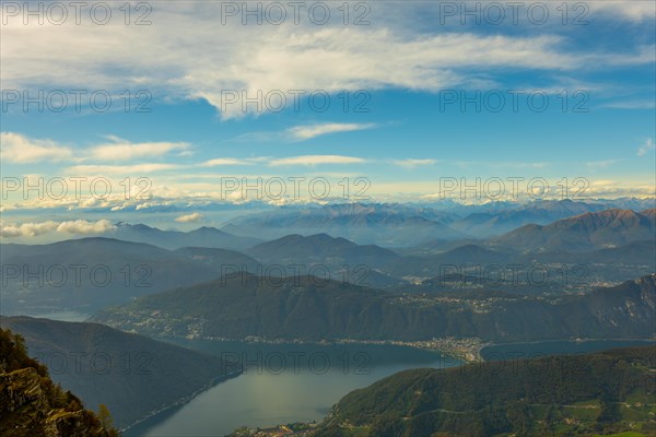 Aerial View over Beautiful Mountainscape with Clouds and Lake Lugano in a Sunny Day From Monte Generoso
