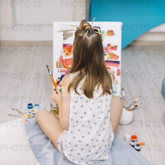 Girl white sitting floor painting with gouache