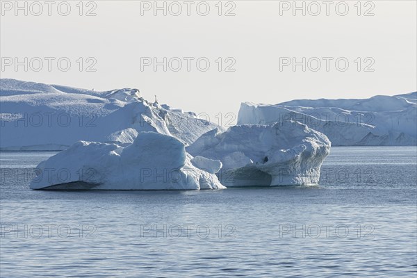 Icebergs in the UNESCO World Heritage Ilulissat Icefjord in the evening sun. Disko Bay