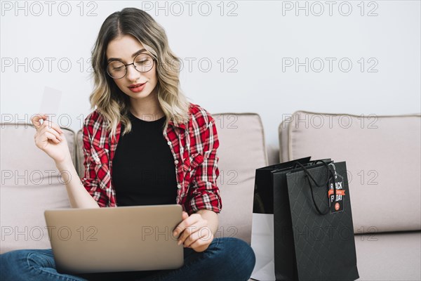 Woman sitting couch studying sales black friday