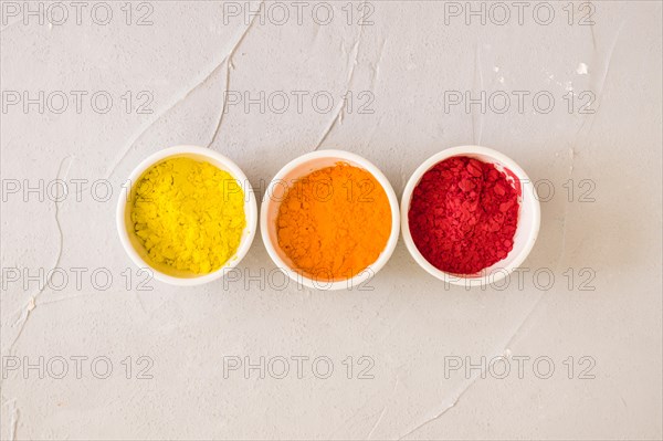 Elevated view white bowls with holi color powder simple background