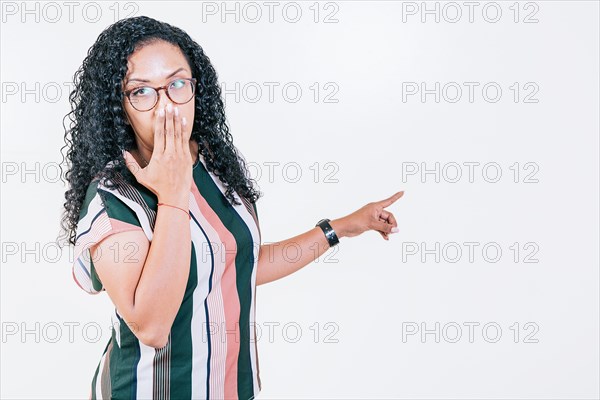 Afro young woman pointing an advertising isolated. Girl in glasses pointing to a banner to the side. Funny people pointing a promo isolated