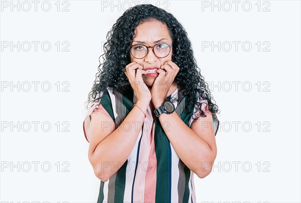 Worried young woman biting her nails isolated. Anxious afro woman biting her nails
