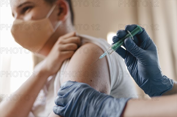 Doctor giving kid vaccine while wearing gloves