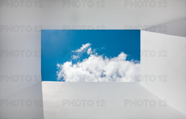 Perspective of clouds from frame shaped walls. perspective of sky and clouds from white walls. White walls with clouds and sky in the background in the form of a frame