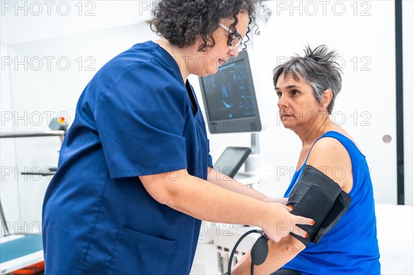 Cardiologist using a stethoscope to listen to the heartbeats of an aged woman