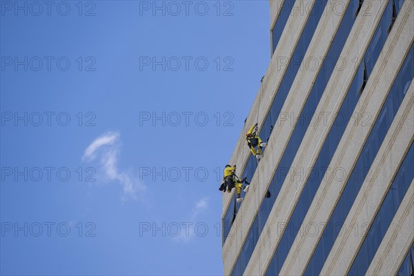 Window cleaner on a high-rise facade