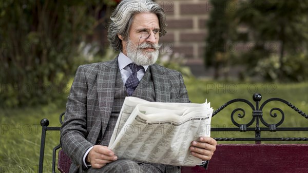 Front view modern man reading newspaper