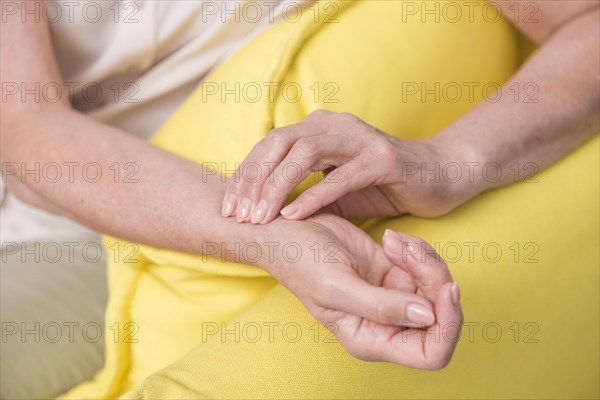 Close up woman s hand checking wrist pulse