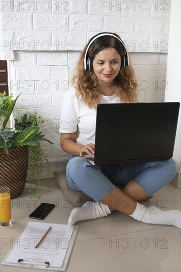 Full shot woman working with laptop