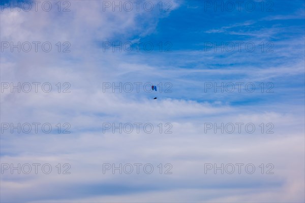 Aerial View over Beautiful Clouds and a Paraglider Flying with Sunlight in Ticino