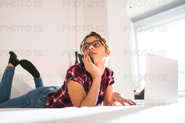 Low angle view of a beauty distracted woman working from an hotel room