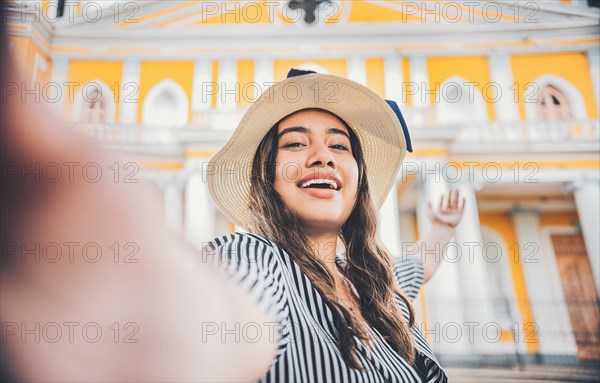 Girl lifestyle taking a self portrait in the square. Granada