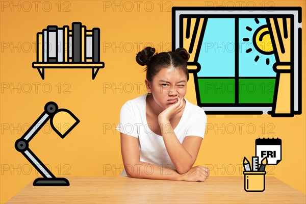 Asian woman making funny faces resting iconos desk