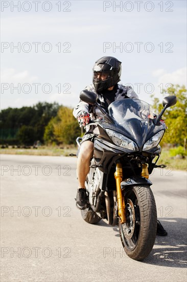 Biker riding road