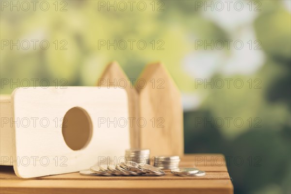 Coins spilling from wooden piggybank table