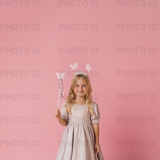 Cute little girl with wand copy space