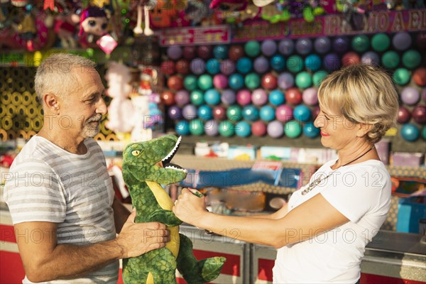 Medium shot people with dinosaur toy