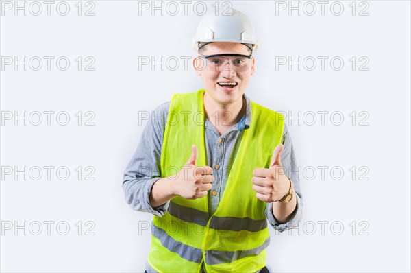 Positive young engineer showing ok gesture isolated. Handsome engineer gesturing ok approved isolated