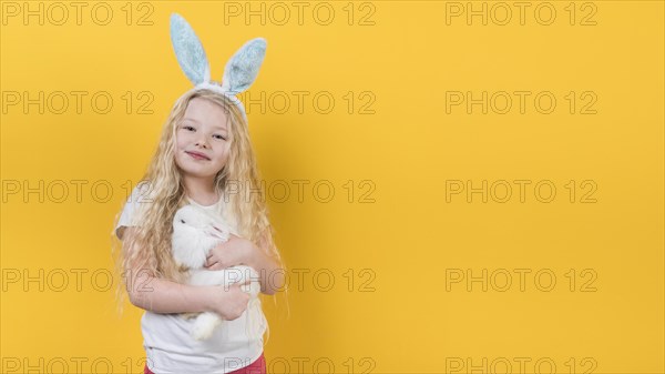 Blond girl bunny ears with rabbit
