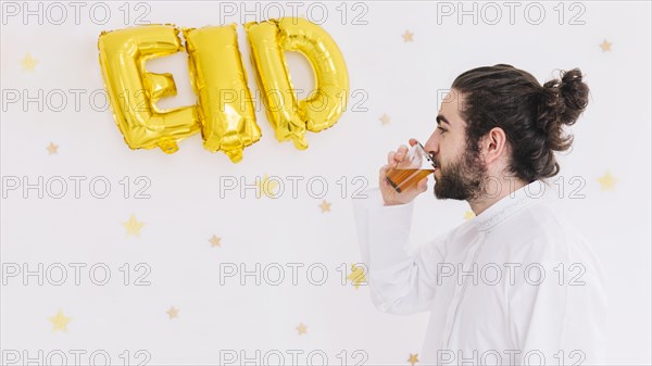Eid al fitr concept with man drinking tea