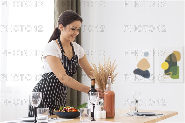 Medium shot woman arranging plant