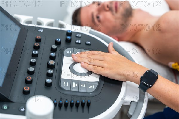 Rear view of a man on a stretcher during the cardiac test of the electrocardiogram